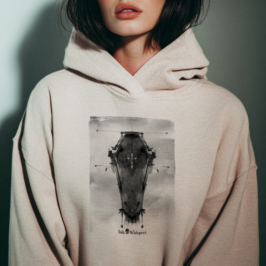 Person wearing a beige hoodie with a graphic design on a plain background