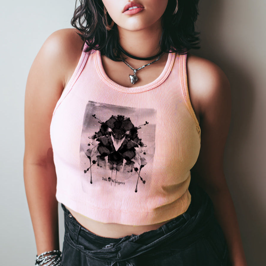 Woman wearing a pink tank top with a black graphic design against a plain background