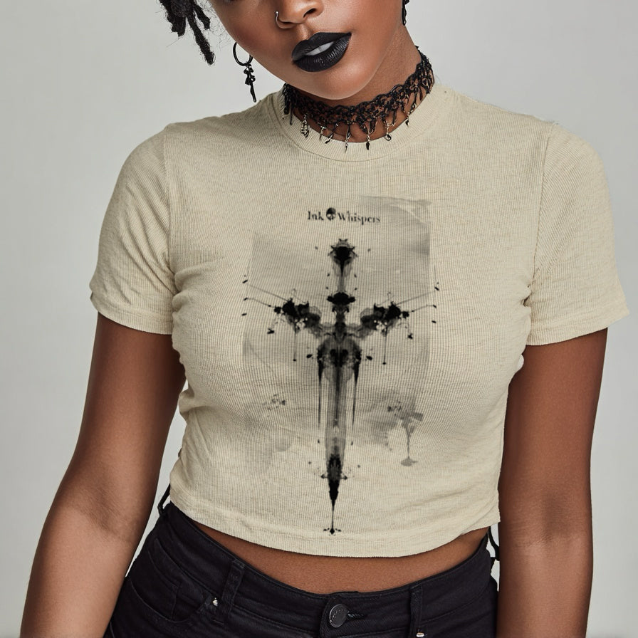 Person wearing a beige t-shirt with a graphic design on a plain background