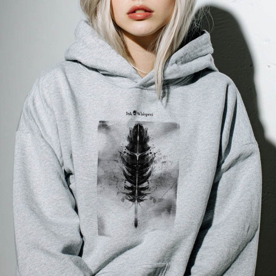 Person wearing a gray hoodie with a black and white design on a plain background
