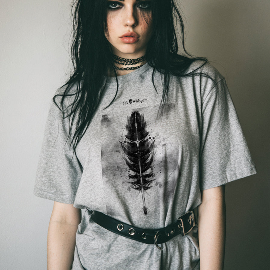 Person wearing a gray t-shirt with a feather design against a plain background