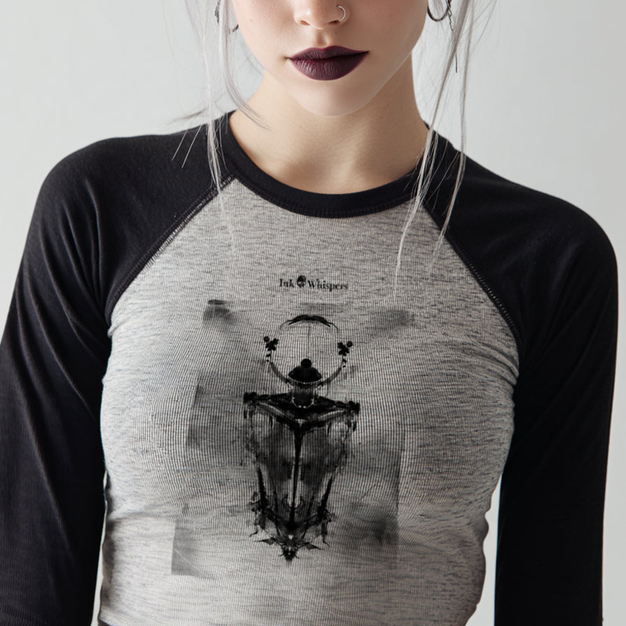 Person wearing a black and gray baseball shirt with a graphic design on a plain background