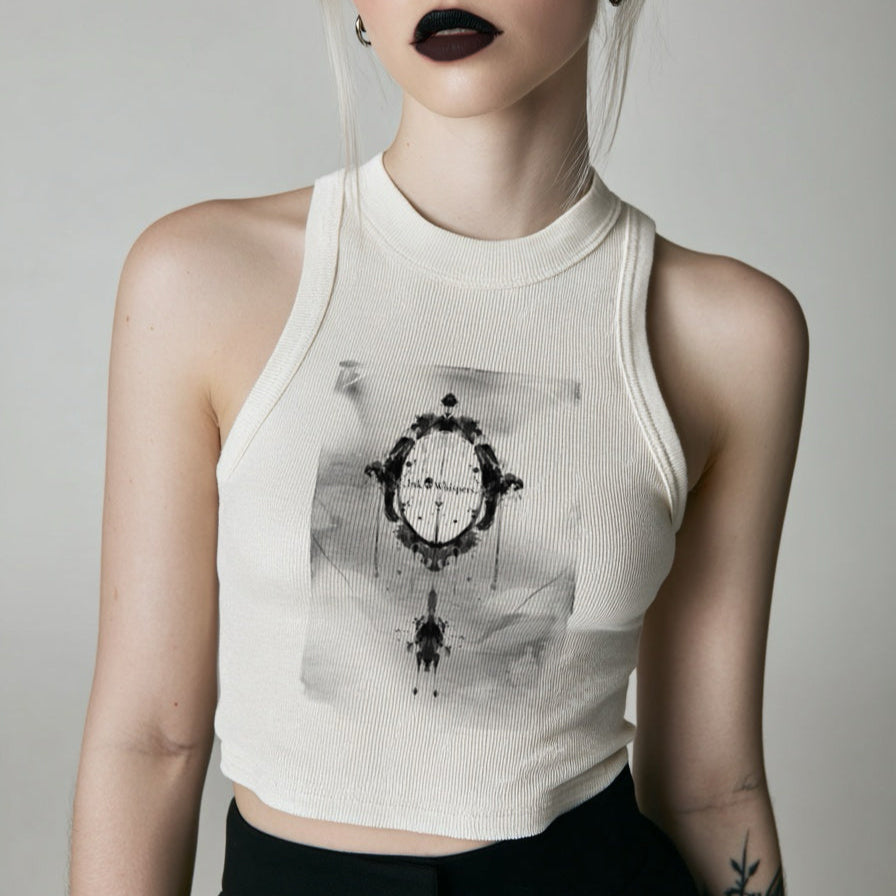 Person wearing a white tank top with a graphic design on a plain background