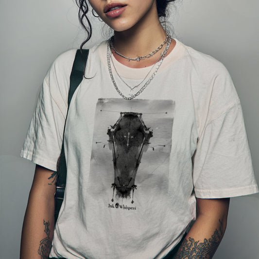 Person wearing a t-shirt with a graphic design on a plain background
