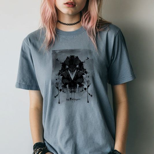 Person wearing a gray t-shirt with a black graphic design against a plain background