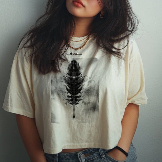 Person wearing a white t-shirt with a black feather design against a plain background