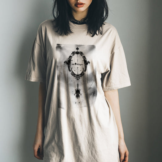 Woman wearing a beige t-shirt with a graphic design on a plain background