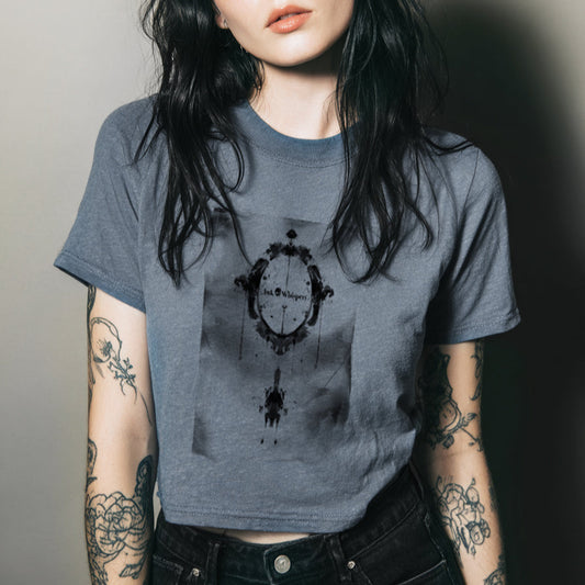 Person wearing a gray t-shirt with a graphic design, standing against a plain background